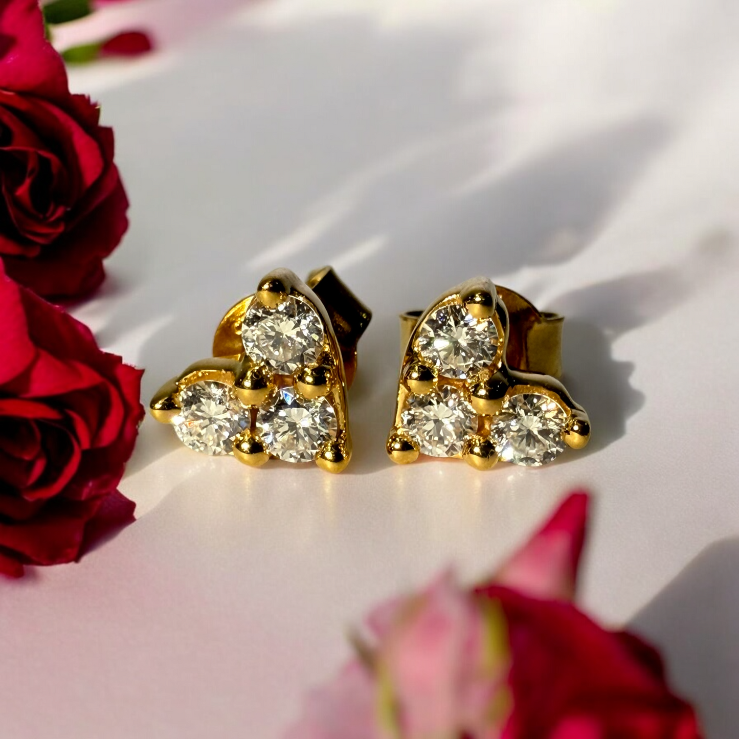 TRIPLE STONE HEART DIAMOND STUDS