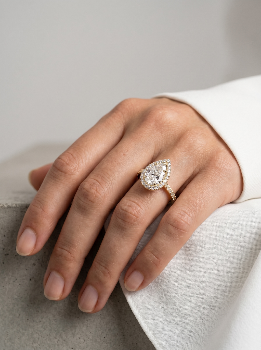Signature Pear Halo Solitaire ring