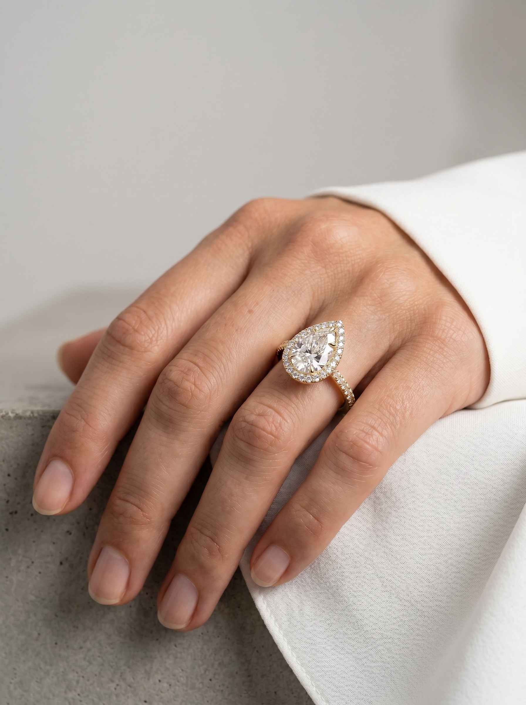 Signature Pear Halo Solitaire ring